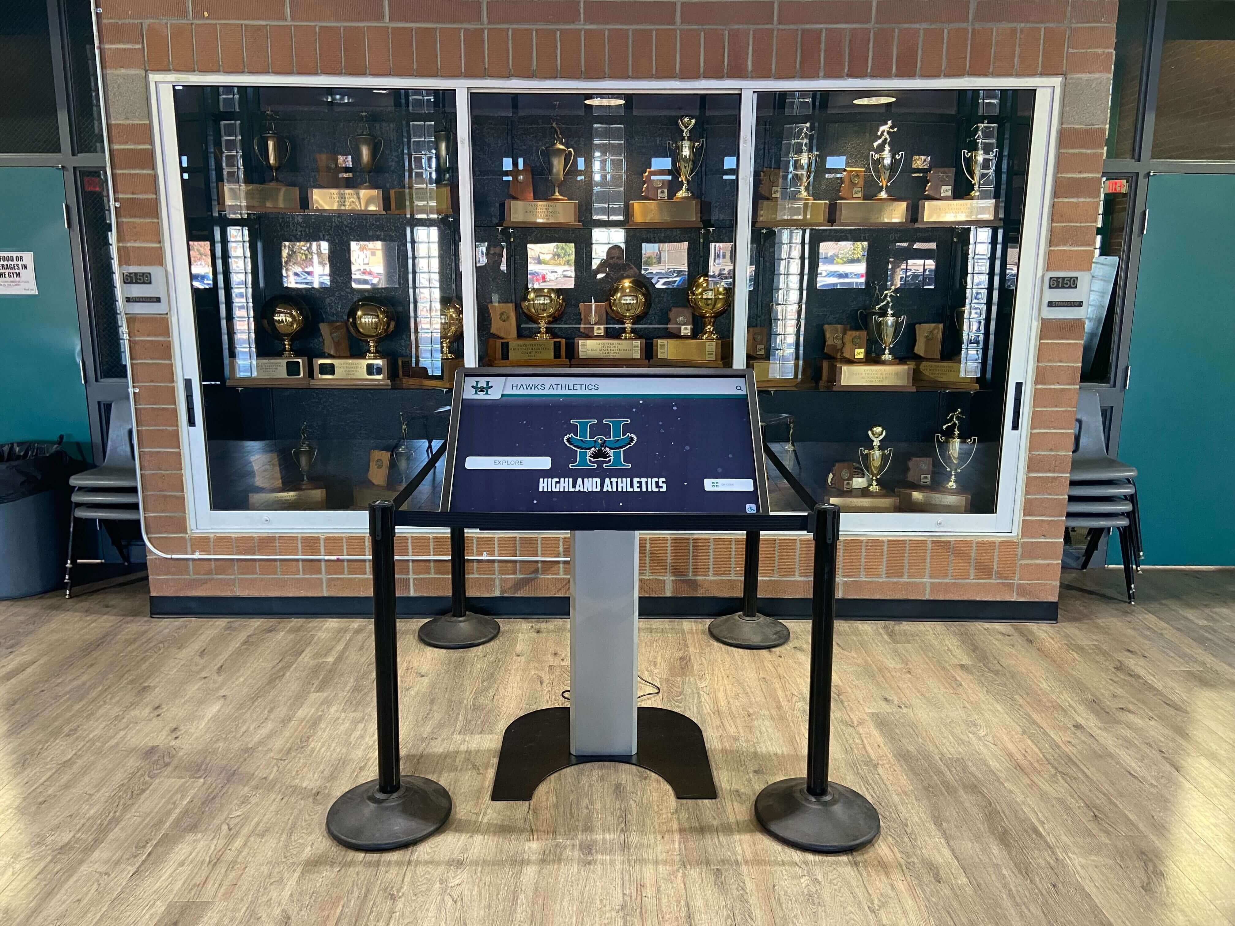 Athletics touchscreen kiosk installed in a school trophy case display area Athletics touchscreen kiosk in school trophy case area