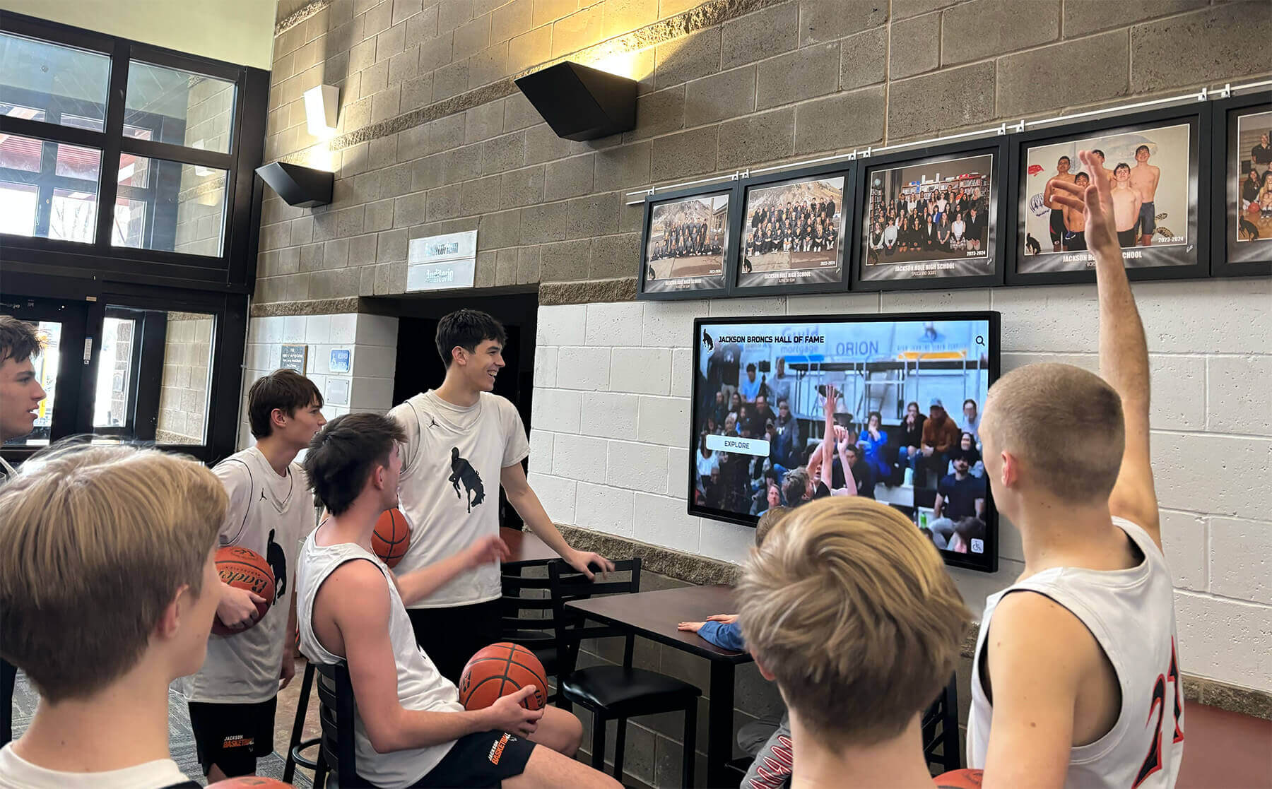Students engaging with achievement displays Students viewing recognition