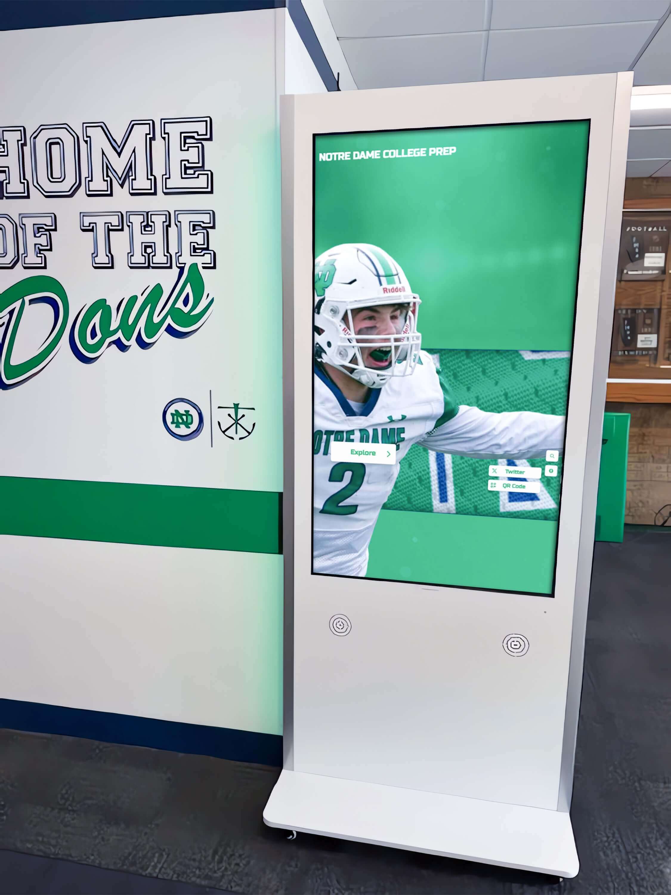 Interactive football hall of fame kiosk display in a school hallway Interactive kiosk in school hallway