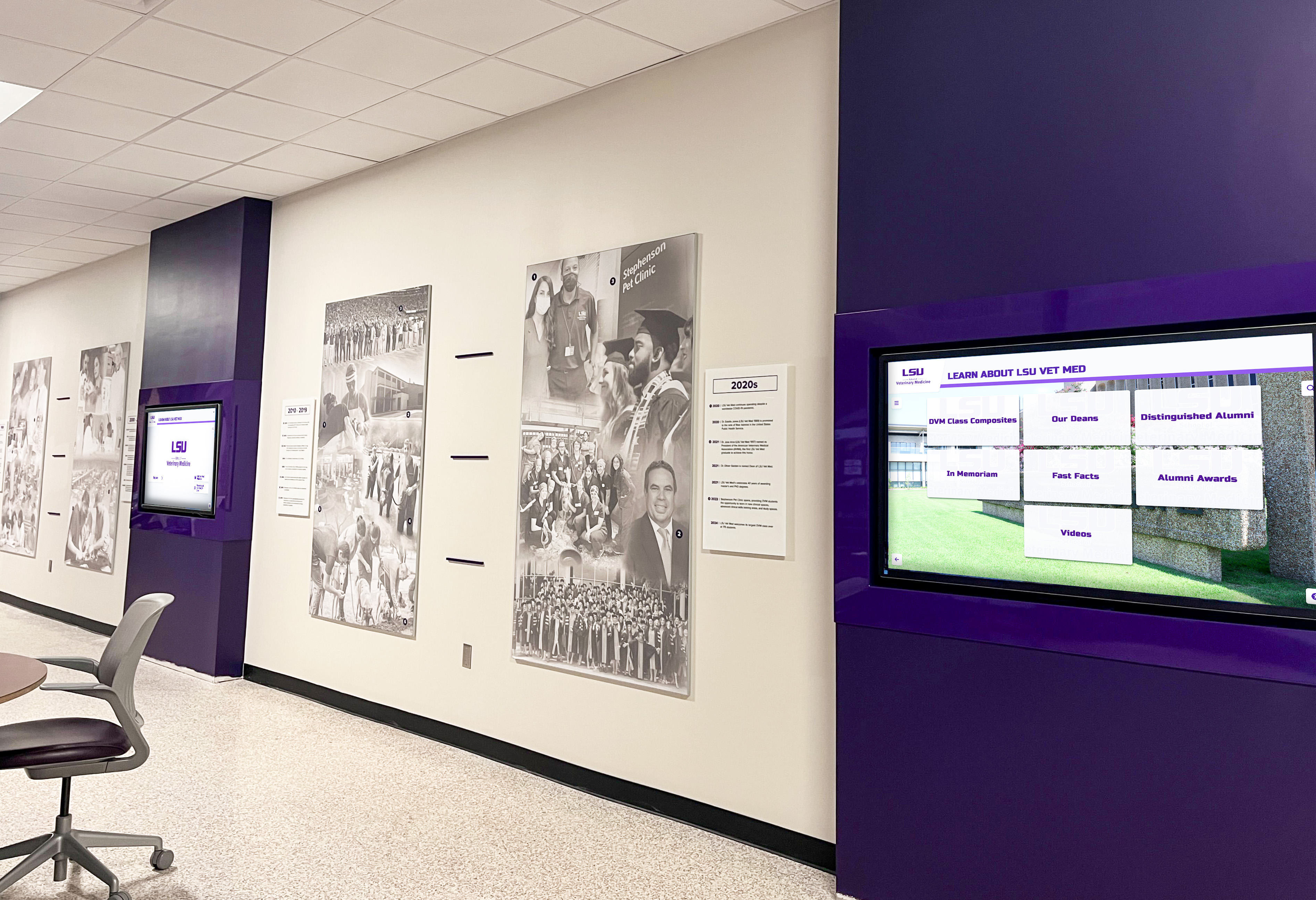 Digital display screens showing content in a university hallway Digital displays installed in a university hallway corridor