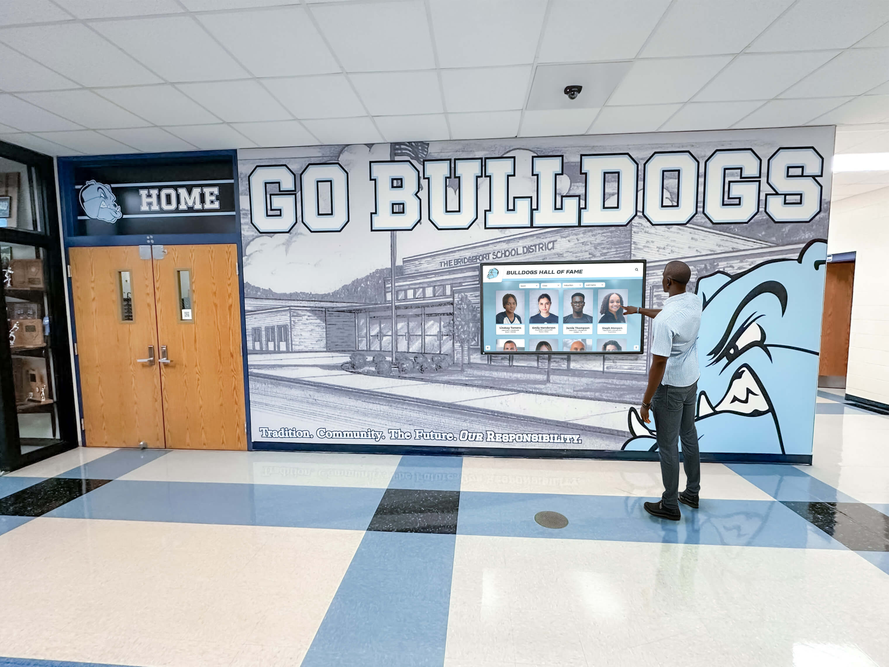 Man using an interactive digital hall of fame screen installed in a school corridor Visitor interacting with a hall of fame display screen in a school hallway