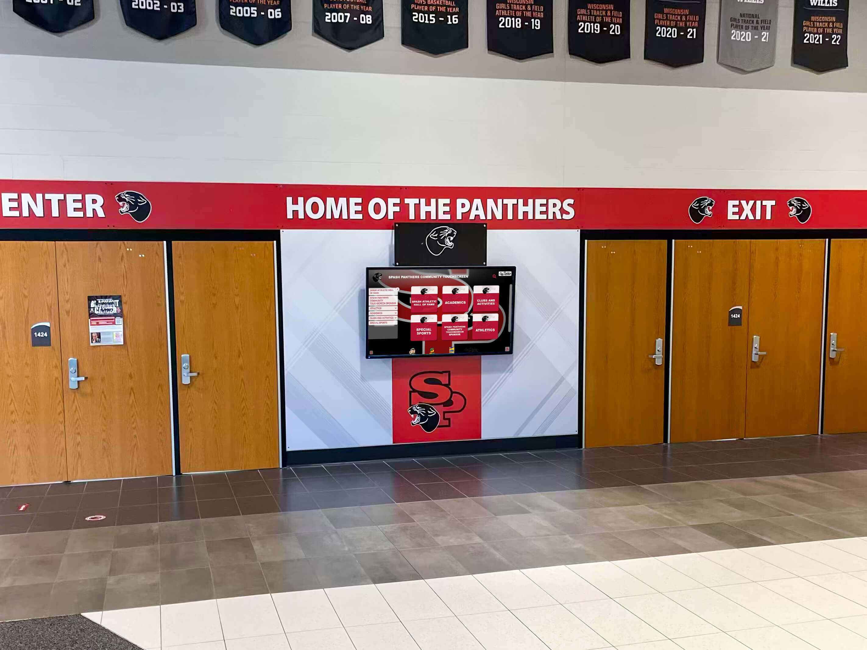 School hallway digital screen showing Panthers branding at the building entrance School hallway digital recognition screen